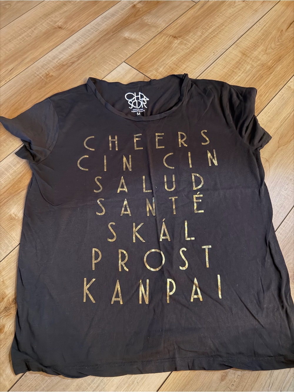 Chaser Black Tee with Gold Multilingual Cheers Print